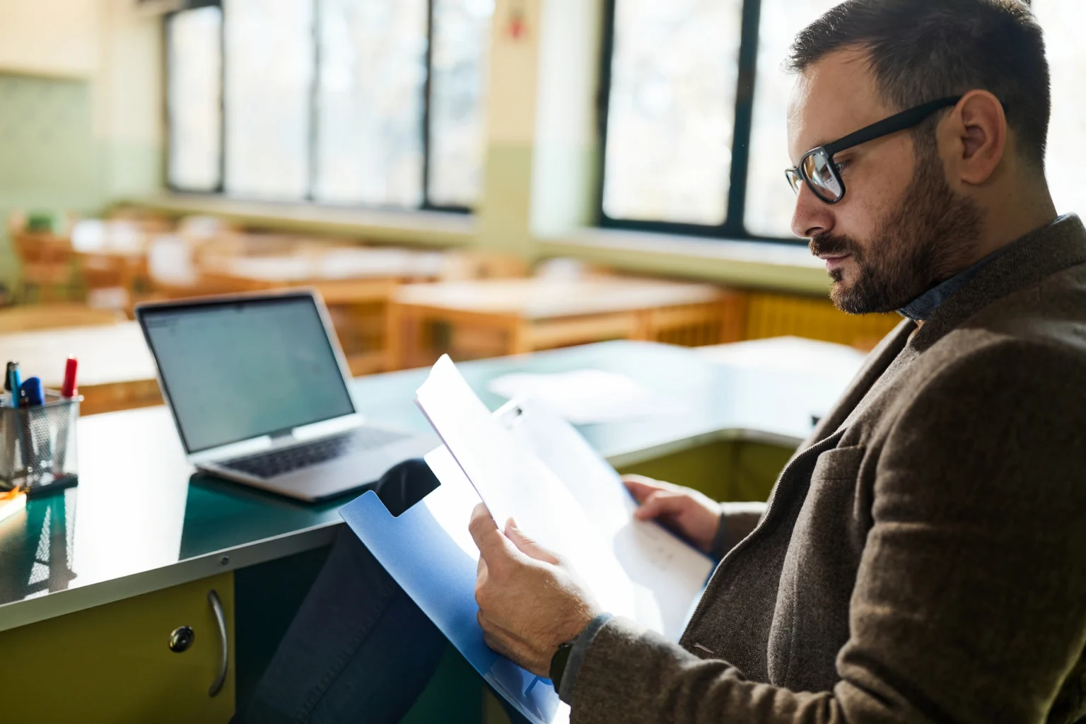 tutor grading papers at his desk